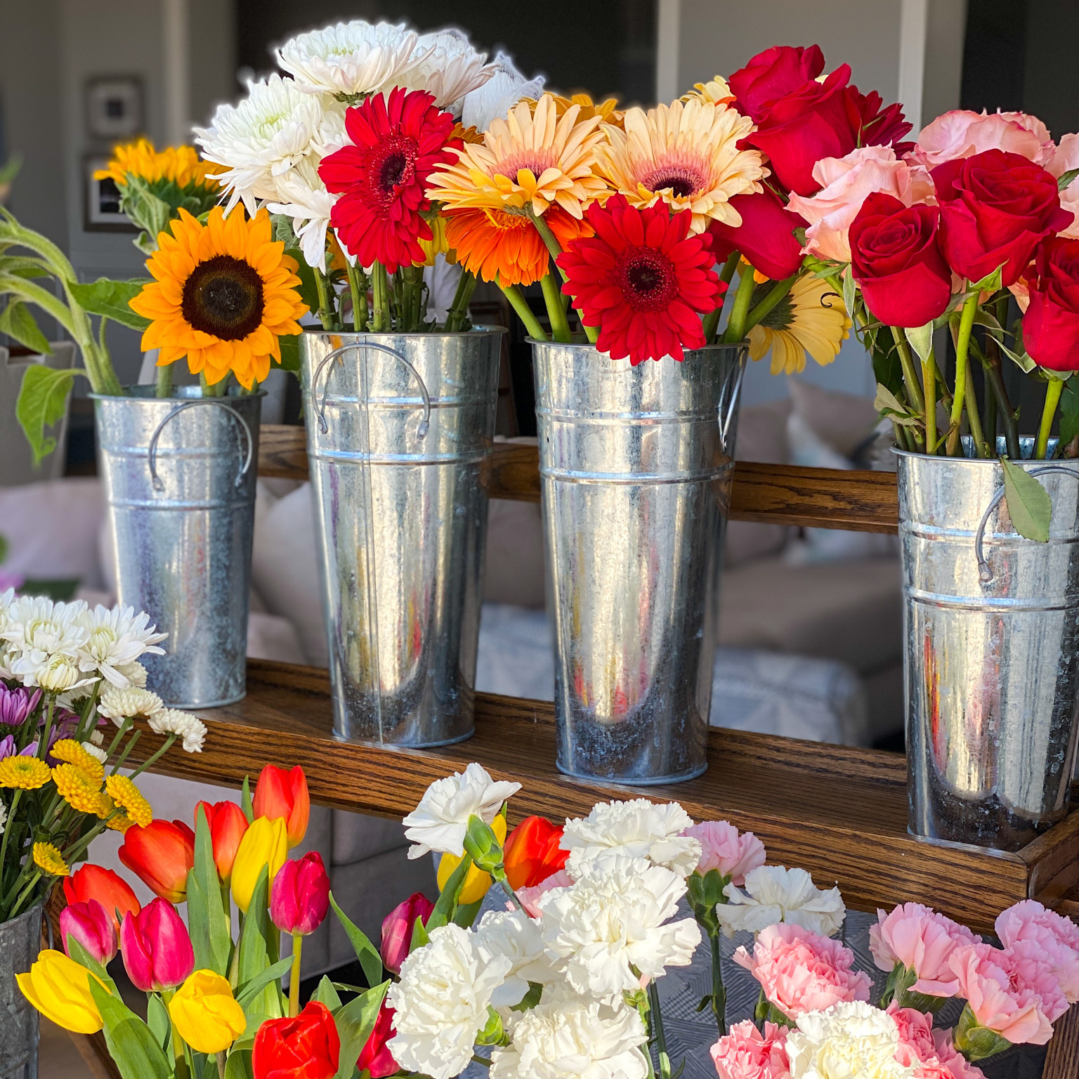 Flower bouquets in metal vases.